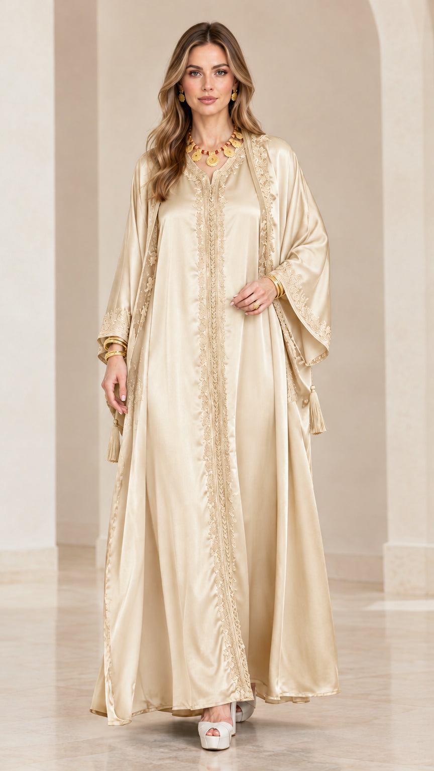 Front view of model wearing a champagne gold satin embroidered kaftan maxi dress