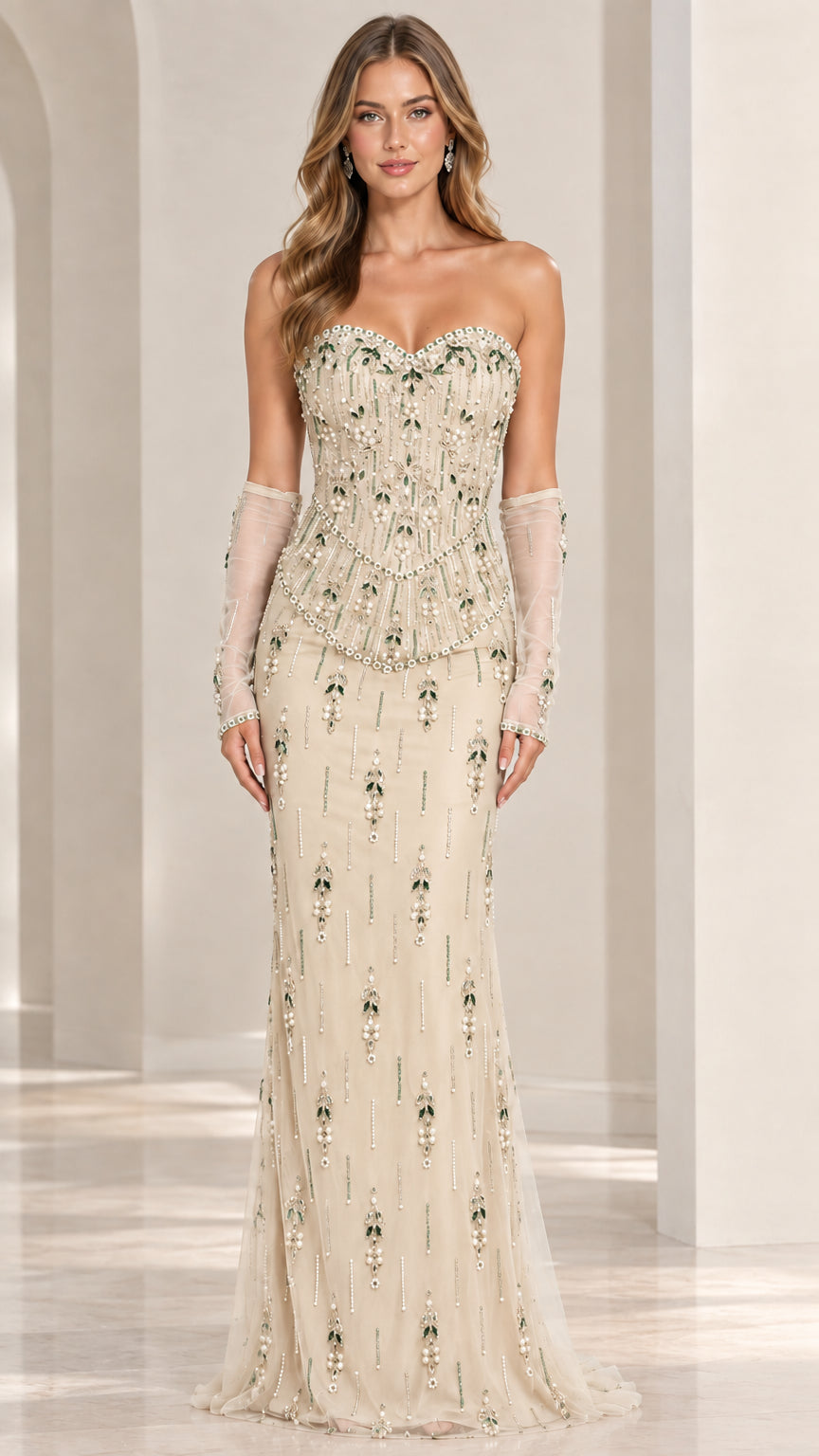 Front view of model wearing champagne strapless beaded evening gown with sheer gloves